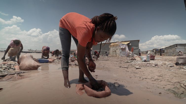 Woman washed what looks like rocks in water.