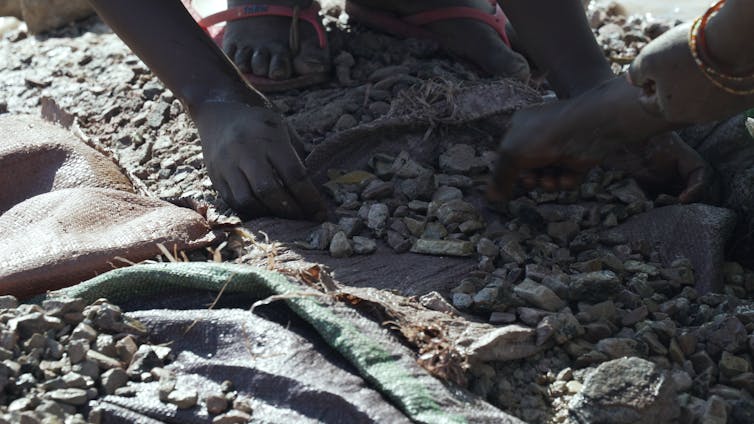 Close up of hands washing ore.