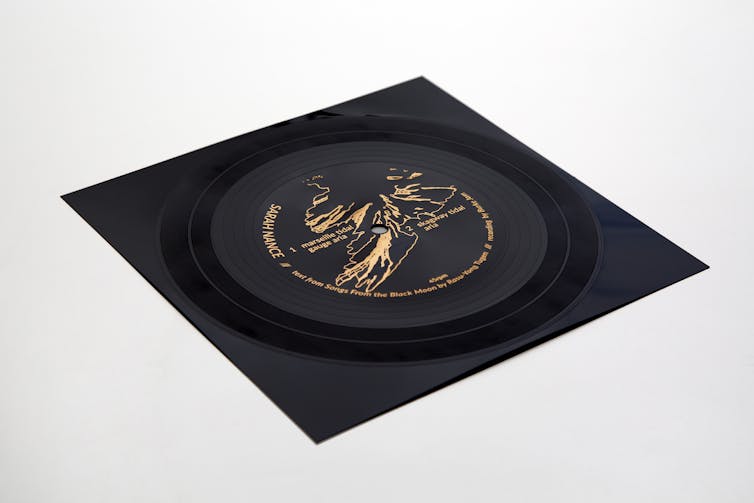 Black flexi disc with gold text and image