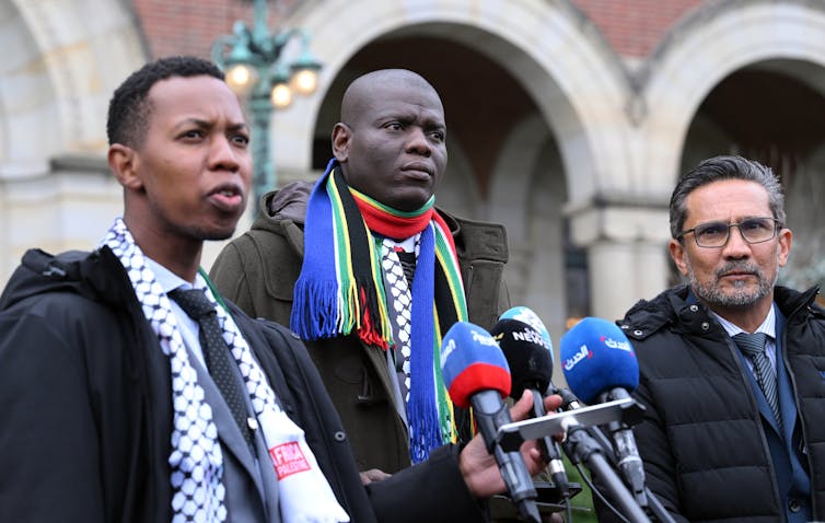 Ronald Lamola, South Africa’s minister of justice and correctional services, center, speaks to the press outside the International Court of Justice in The Hague, Netherlands, on Jan. 12, 2024. Dursun Aydemir/Anadolu via Getty Images