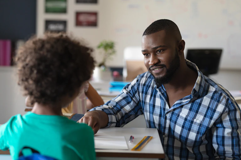 Teacher talking to pupil