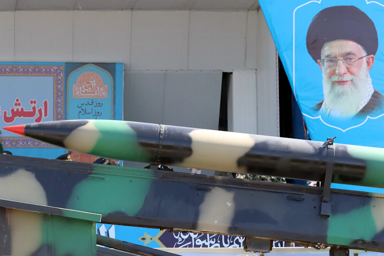 A portrait of Iran's supreme leader, Ali Khamenei, looks over a missile during the annual National Army Day in Tehran, April 2023.