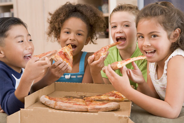 Children sharing a pizza.