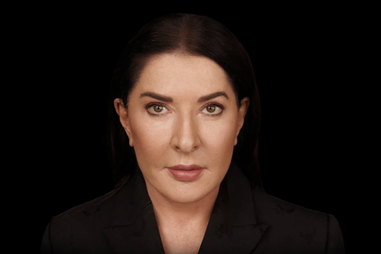 Marina Abramović against a black background.