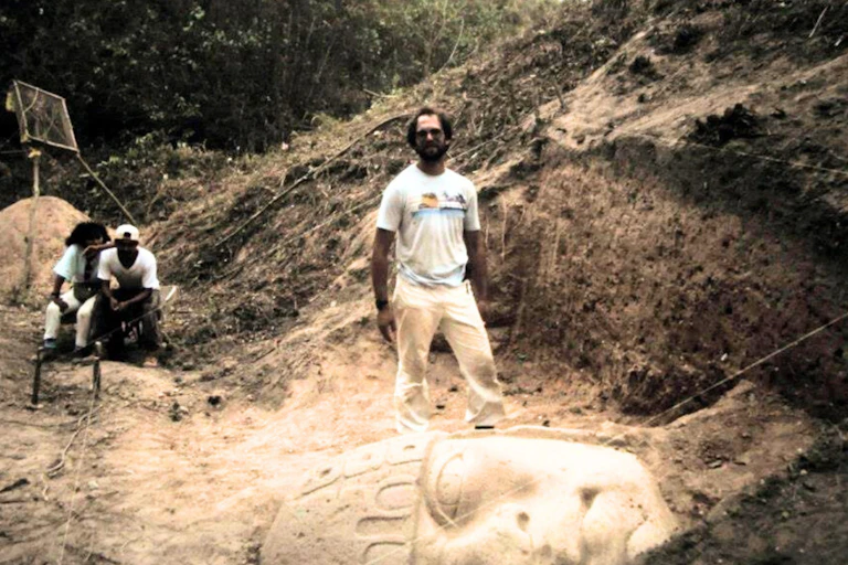 An Archaeologist with a semi-uncovered statue head.