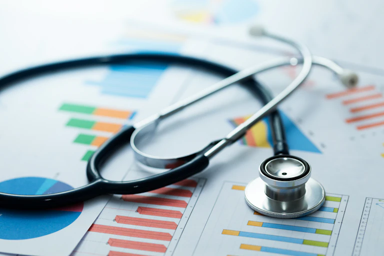 A stethoscope on a pile of bar graphs