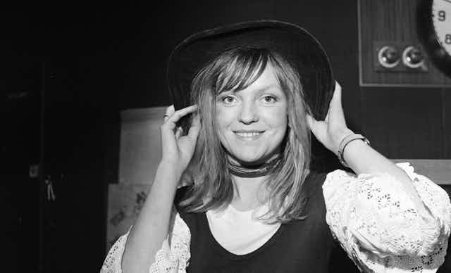 Annie Nightingale in a black hat with long hair. 