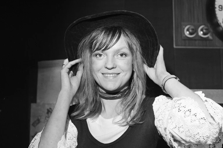 Annie Nightingale in a black hat with long hair.