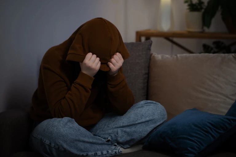 Upset teen on sofa