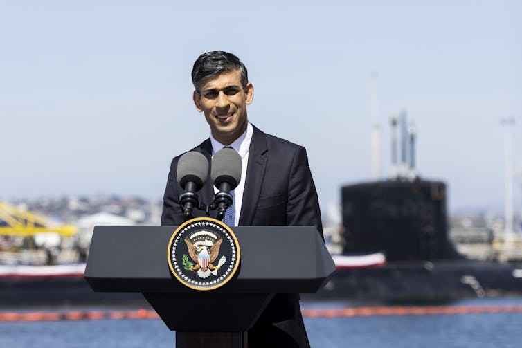 Sunak stood in front of large submarine