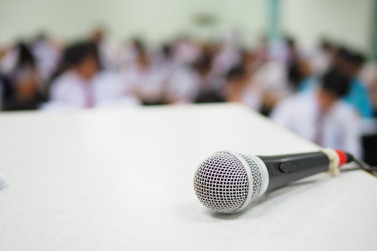 Microphone on a desk in front of the classroom.