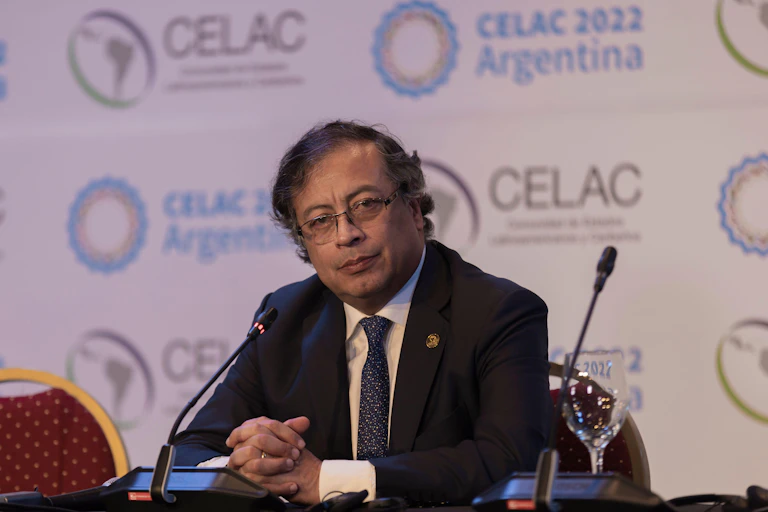 Colombia's president Gustavo Petro sitting at a microphone.