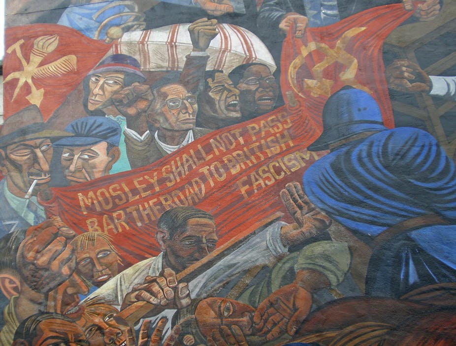 A mural showing an angry crowd pushing agains police, holding a sign that says 'Mosley shall not pass'