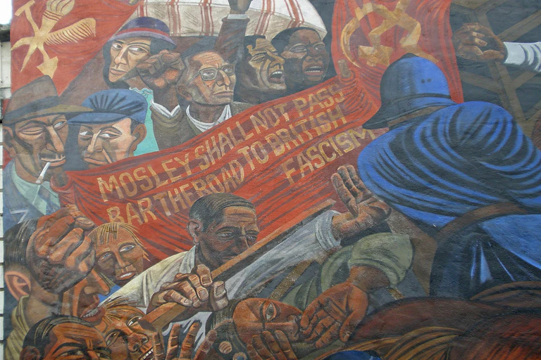 A mural showing an angry crowd pushing agains police, holding a sign that says 'Mosley shall not pass'