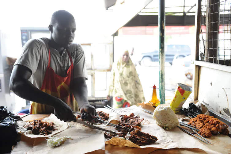 Man roasting meat.