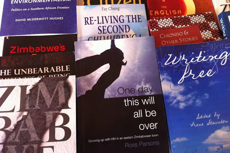 Book covers next to one another, references in titles to Zimbabwe, freedom, environmentalism.