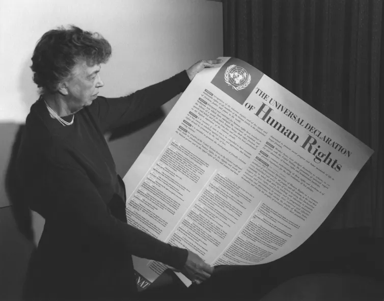 Eleanor Roosevelt holds a copy of the UN Declaration of Human Rights.