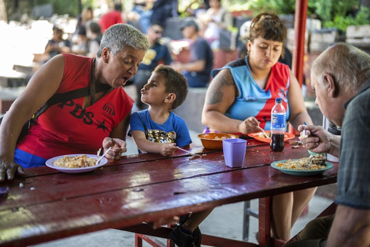 People sit down to a meal
