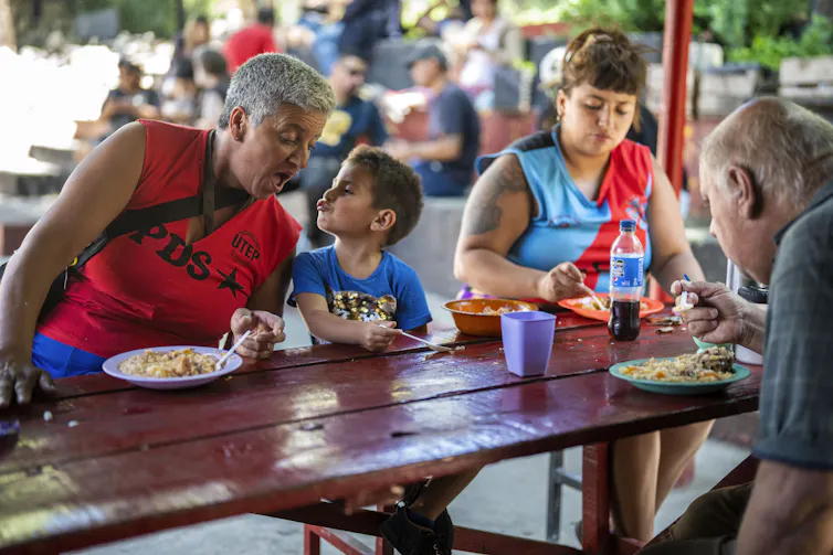 People sit down to a meal