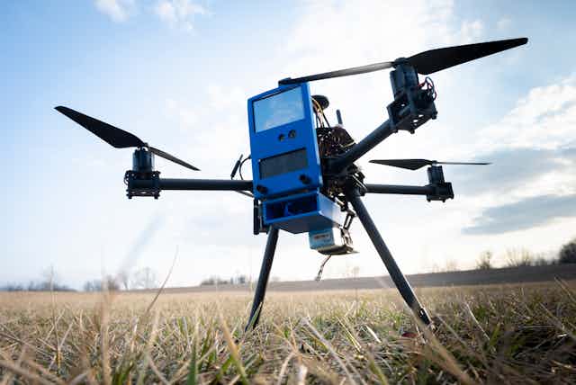 A photograph of a drone in a grassy field.