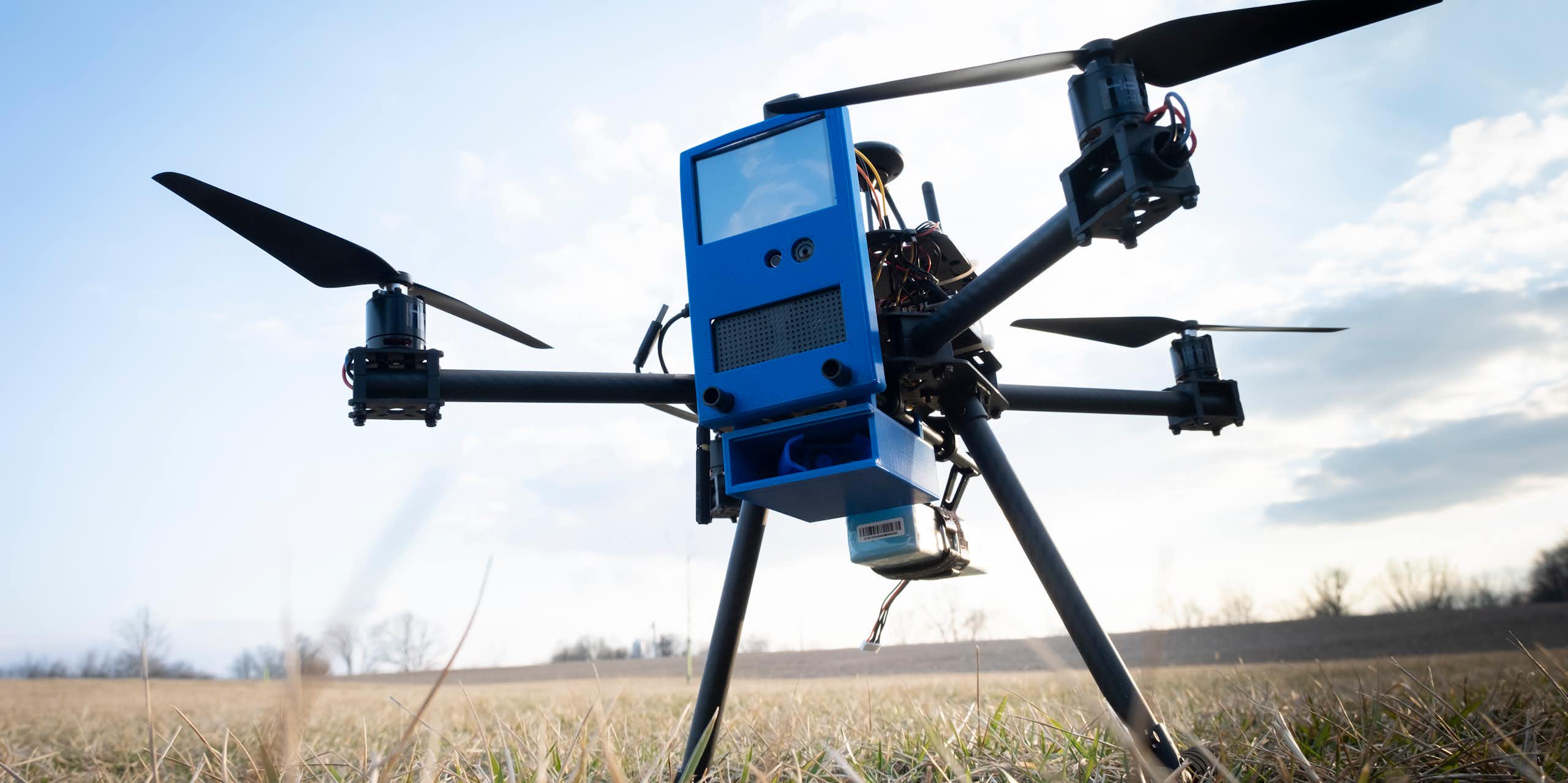 A photograph of a drone in a grassy field.