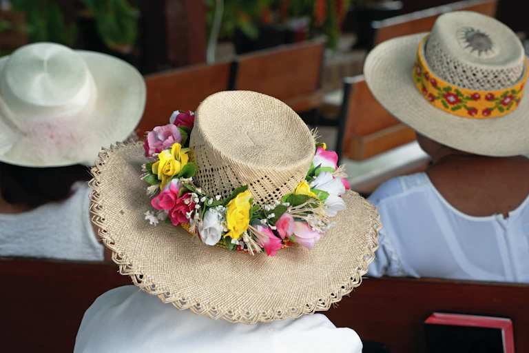 Worshippers, wearing traditional white clothing and straw hats, at the a church in the Pacific Islands