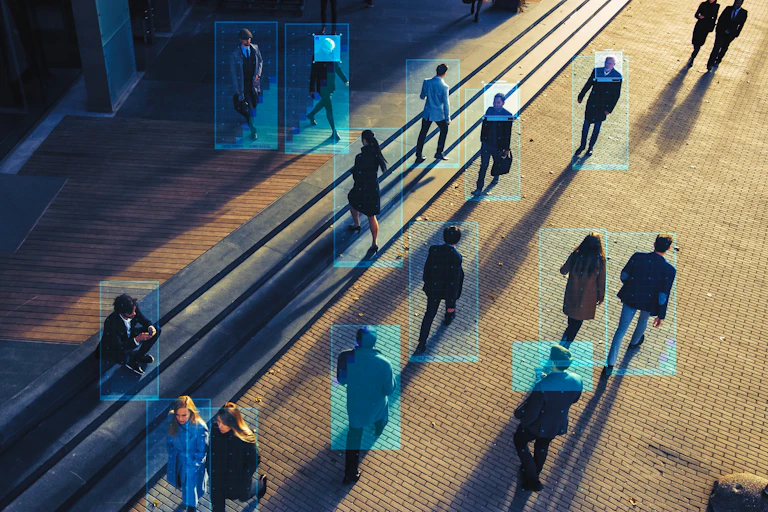 Aerial view of a street full of people with a camera overlay tracking them