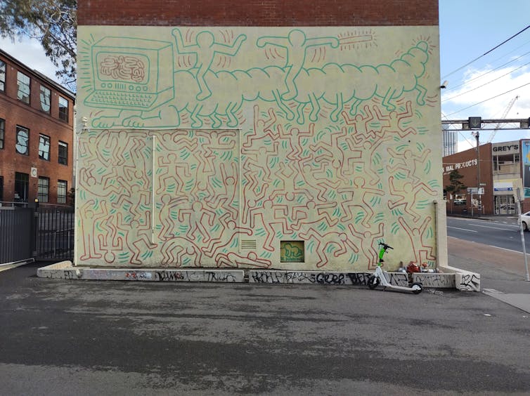 A mural of many human body outlines on a wall