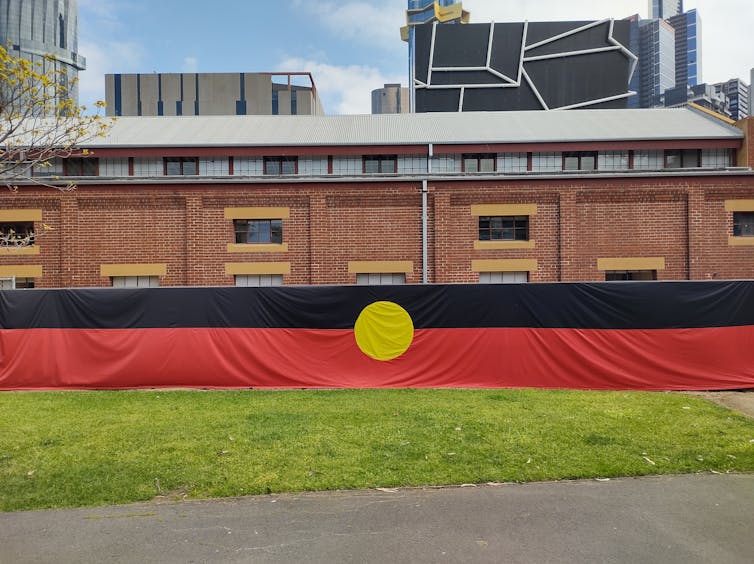 An Aboriginal flag draped the length of a building frontage