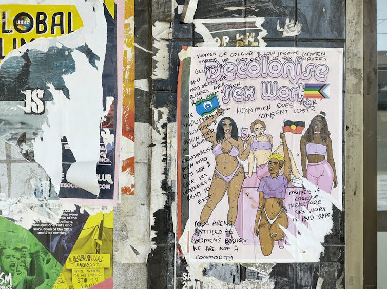 A poster pasted on a wall is covered in handwritten comments