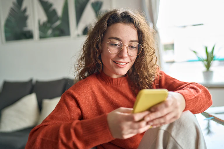 A young women looking at her phone.