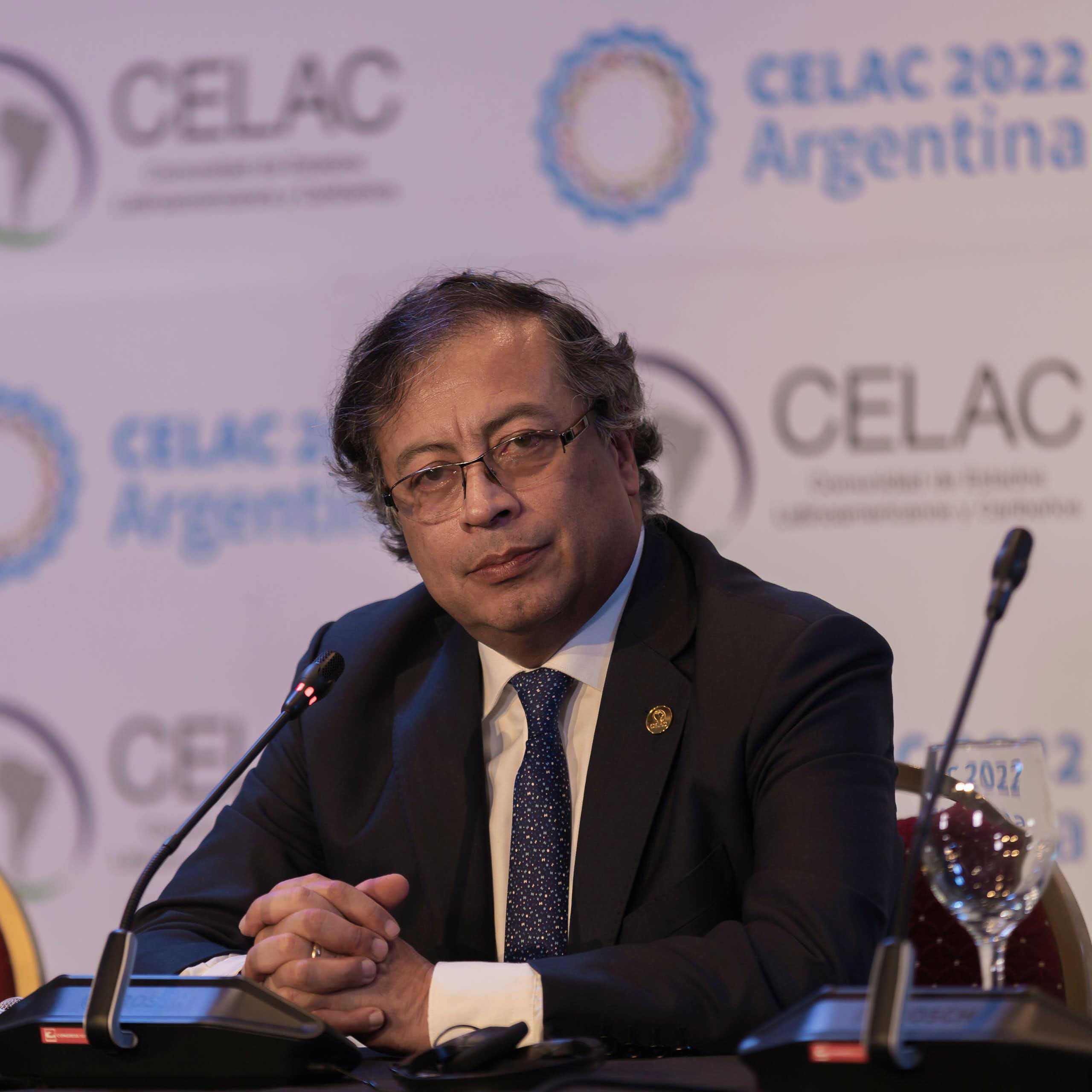 Colombia's president Gustavo Petro sitting at a microphone.