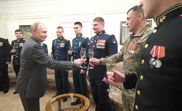 Vladimir Putin shakes hands with military officers, January 2024.
