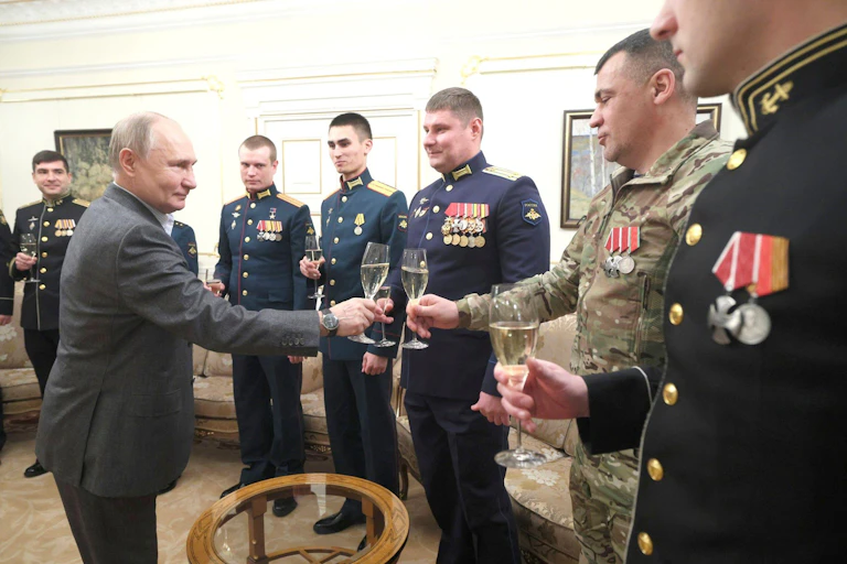 Vladimir Putin shakes hands with military officers, January 2024.