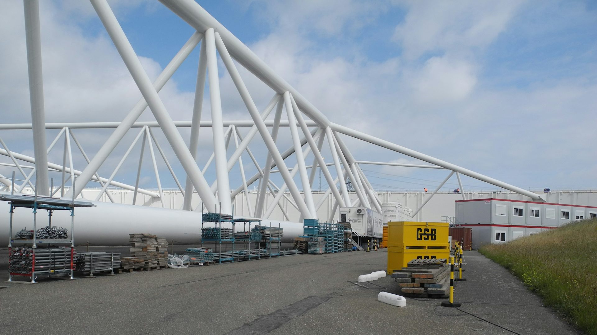 Large white structure with building supplies