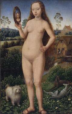 A nude painting in which a woman looks in a mirror. At her feet is a white, pampered-looking dog.