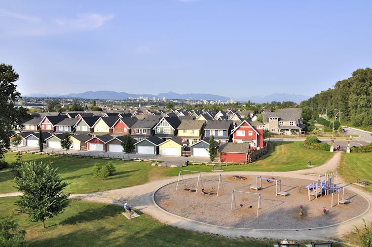 an overhead shot of a row of suburban homes and a playground