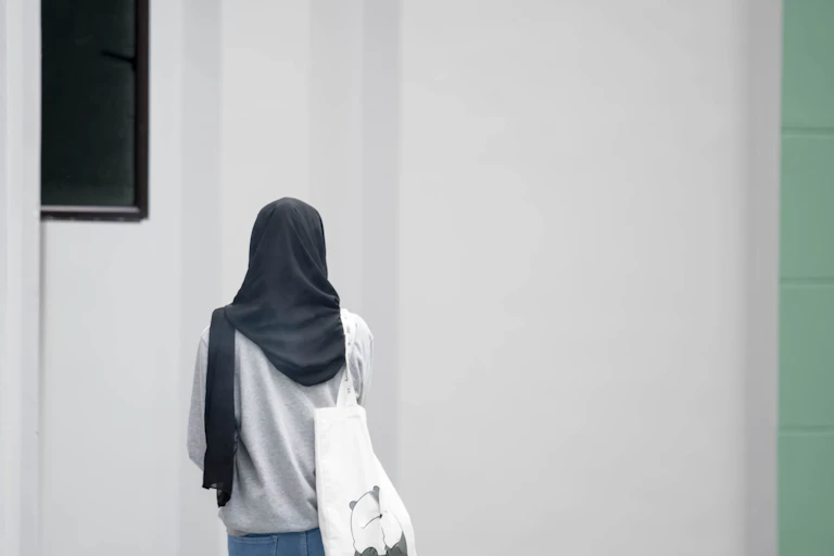 A girl wearing a hijab seen from behind.