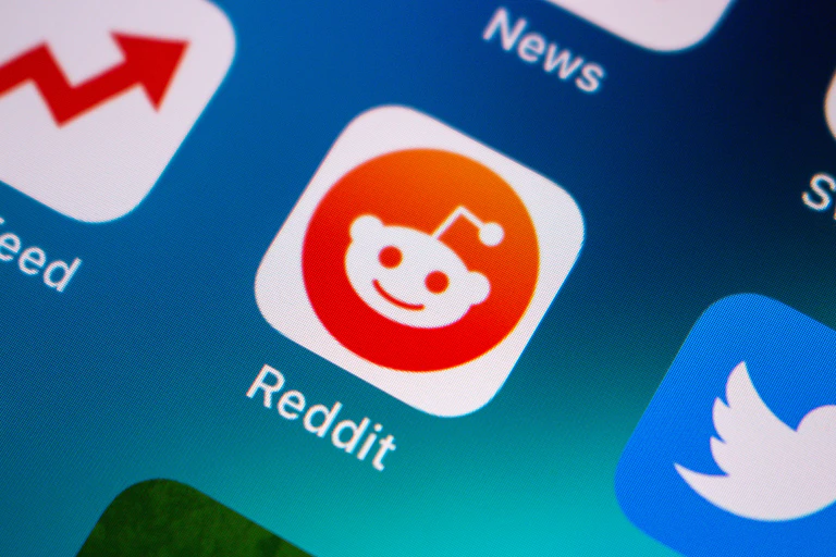 A phone screen displays the Reddit app symbol.