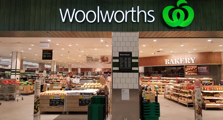 A Woolworths sign is displayed above a shop entrance.