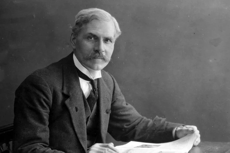 Ramsay MacDonald reading a newspaper.