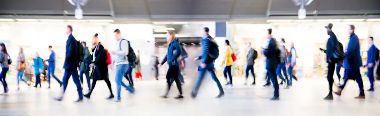 People walking through busy station