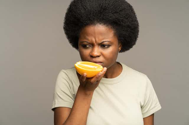 Woman smelling an orange
