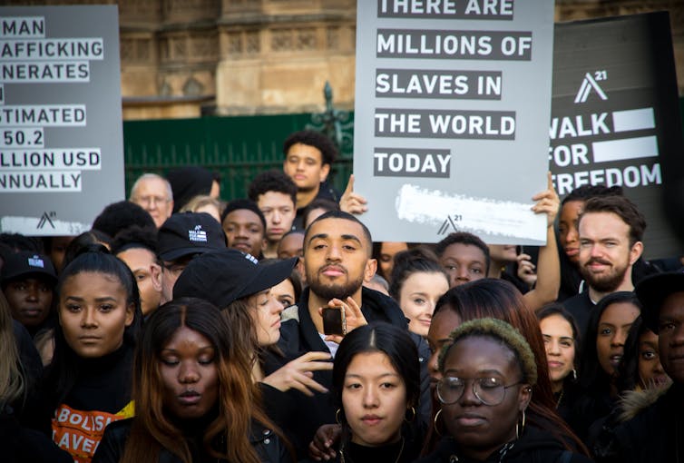 People waving placards at a protest