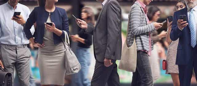 people in business attire walking and holding cellphones