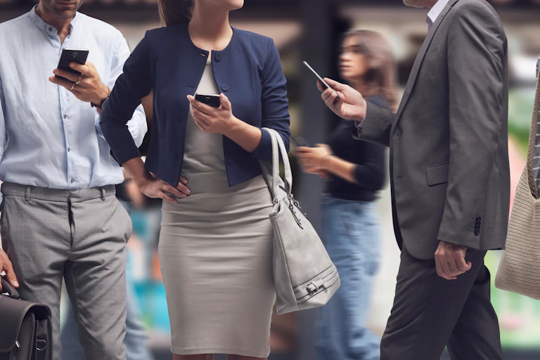people in business attire walking and holding cellphones