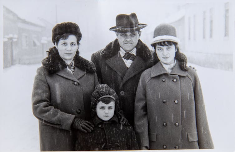 A black and white photograph of a couple with two children.