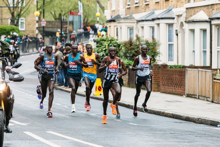 A group of professional marathon runners, including Eliud Kipchoge, at the London marathon.