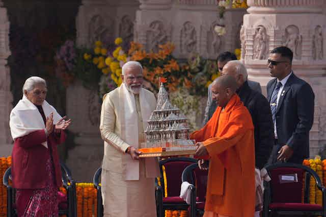 Indian Prime Minister Narendra Modi is handed a model of the Ram temple at Ayodhya by from Uttar Pradesh Chief Minister Yogi Adityanath after the opening of a temple dedicated to Hinduism’s Lord Ram, Monday, Jan. 22, 2024. 