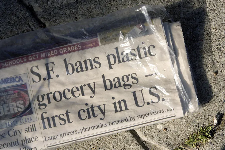 Newspaper in plastic bag with headline that reads 'S.F. bans plastic grocery bags-first city in U.S.'